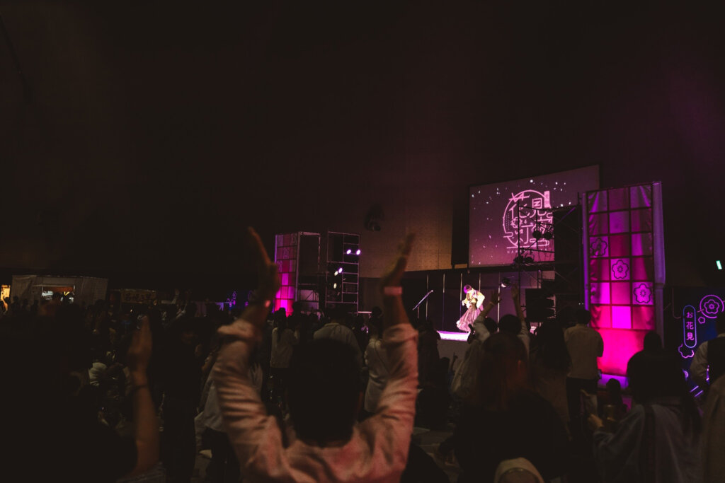 ピンクの照明のステージでライブ